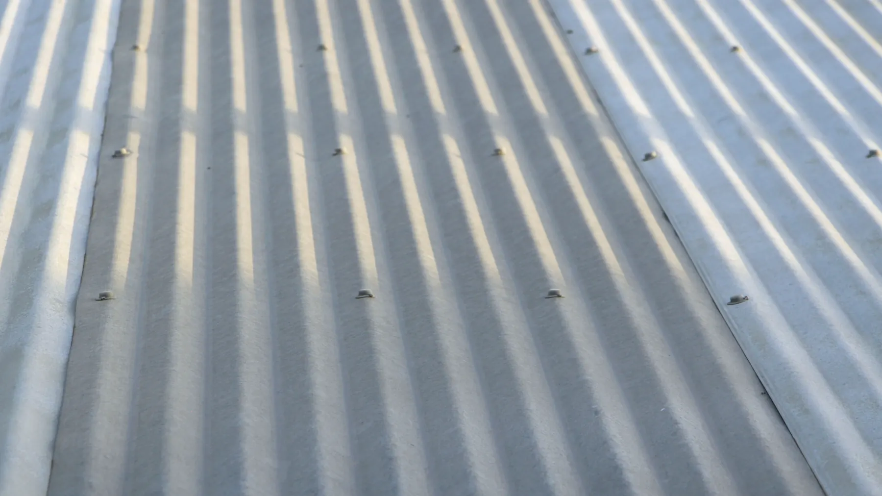 Grey corrugated asbestos-cement roof sheets seen from above